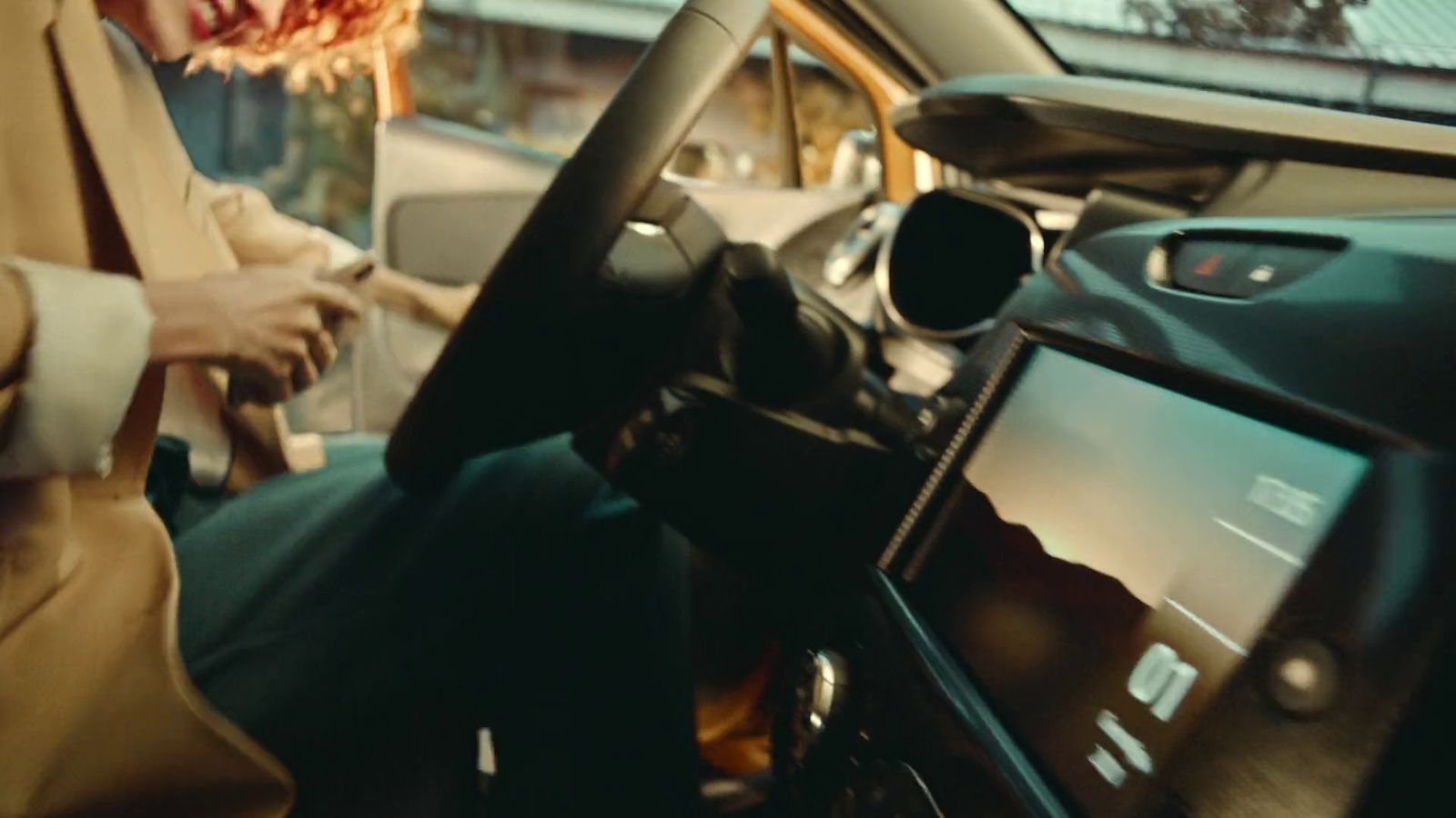 a woman sitting in the driver's seat of a car