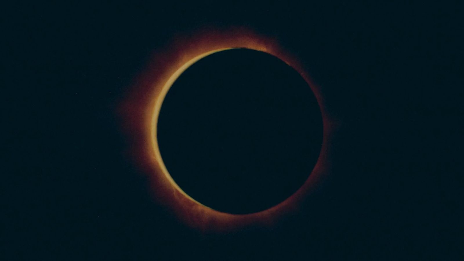 a solar eclipse is seen in the dark sky