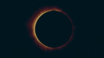 a solar eclipse is seen in the dark sky