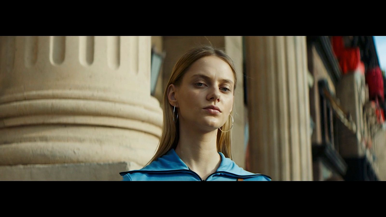 a woman standing in front of a tall building