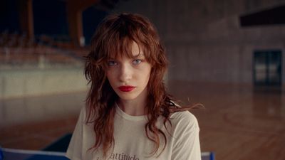 a woman with red lipstick standing in a room