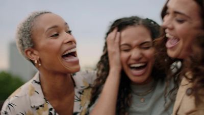 a group of women laughing and laughing together