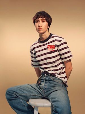 a man sitting on top of a stool