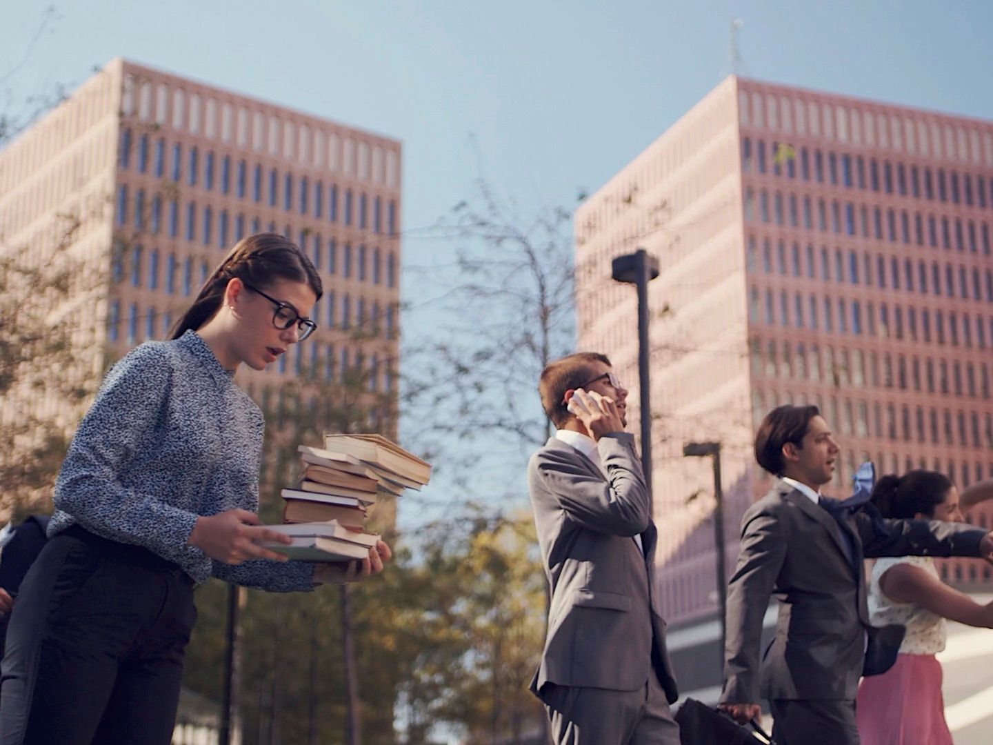 a group of people standing in front of tall buildings