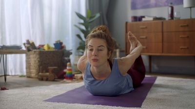 a woman doing a yoga pose in a living room