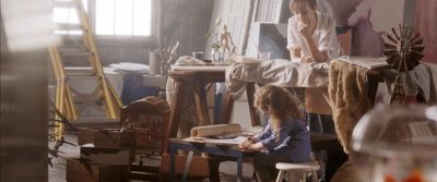 two young girls sitting at a table in a room