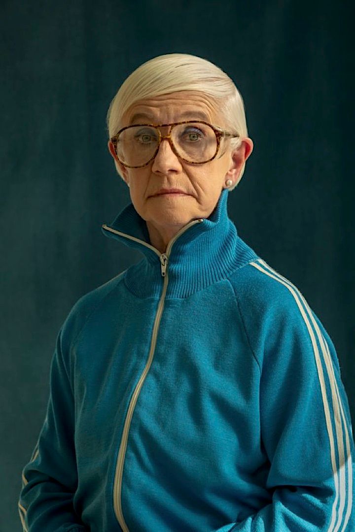 an older woman with glasses and a blue jacket