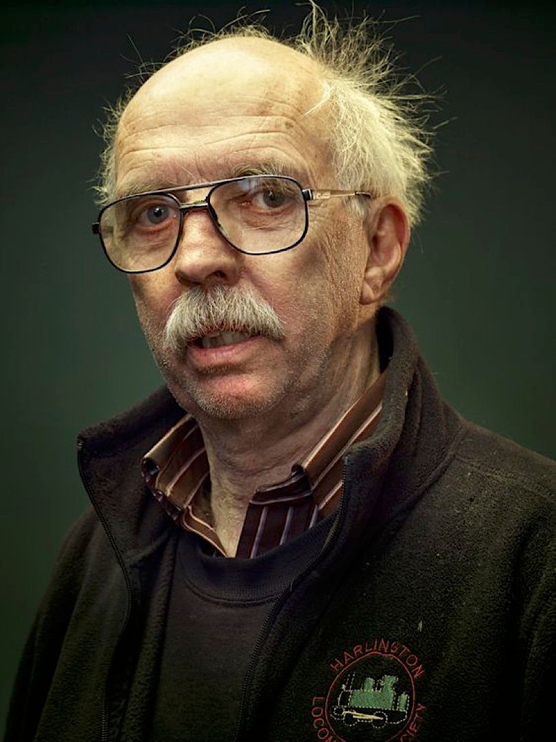 an older man with glasses and a mustache