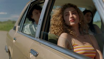 a woman sitting in the passenger seat of a car