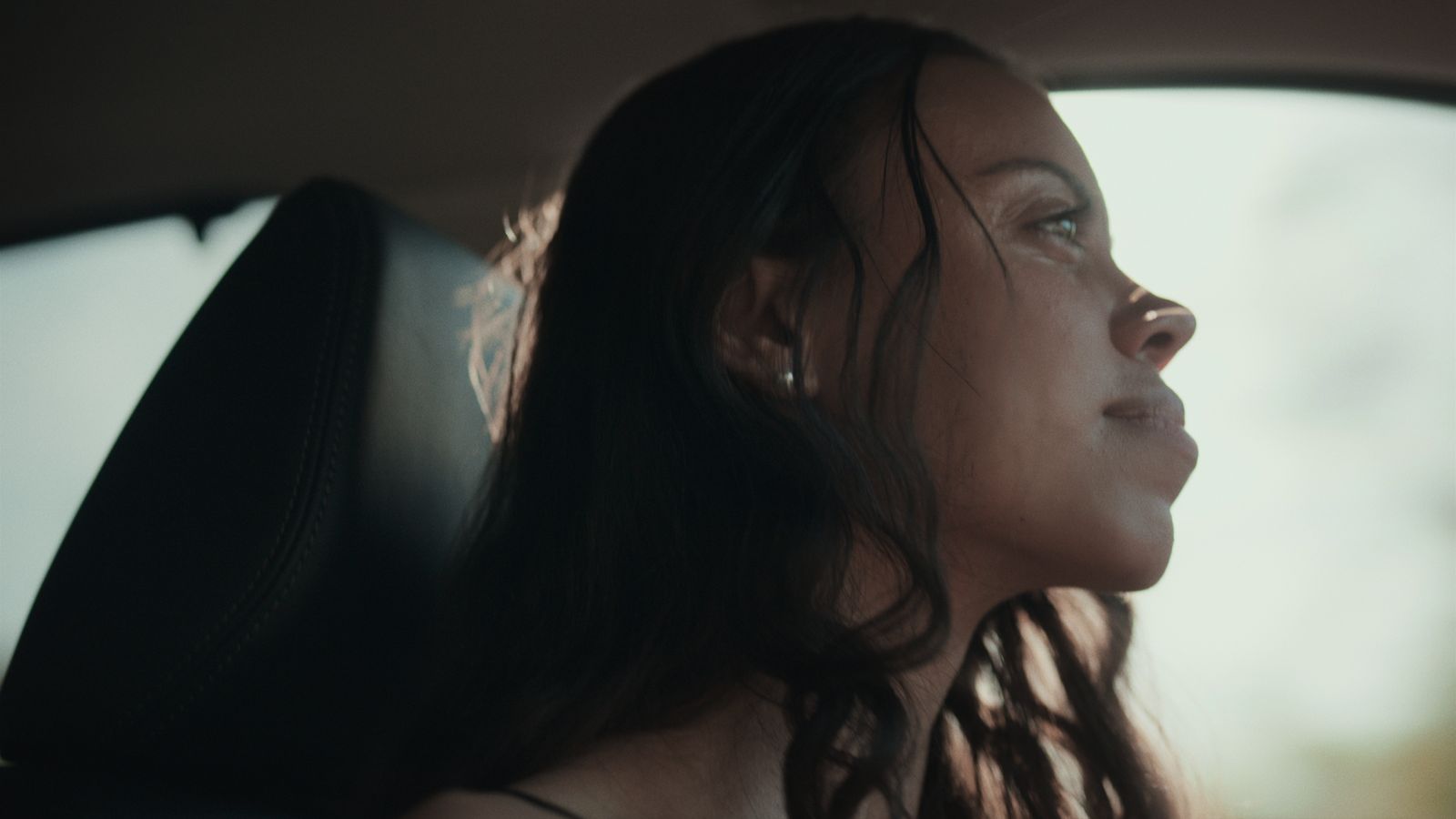 a woman sitting in the back seat of a car