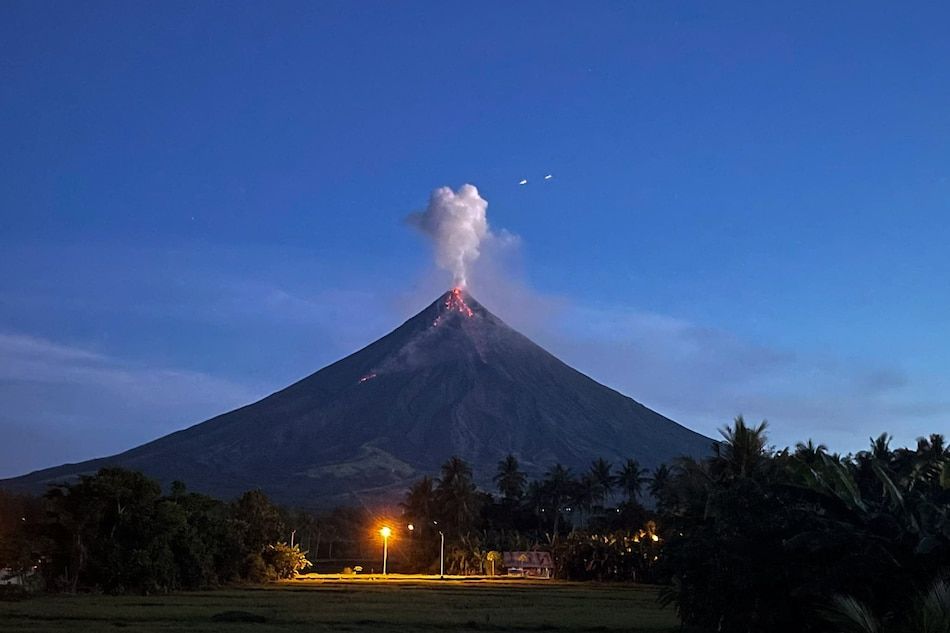 a very tall mountain with a very large cloud coming out of it's top