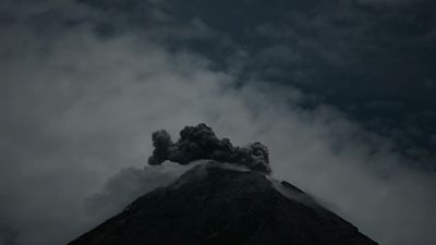 a very tall mountain with a lot of smoke coming out of it