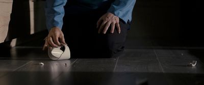 a person standing over a table with a white object on it