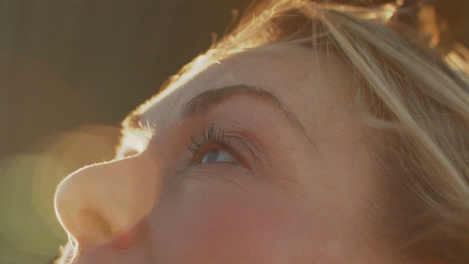 a close up of a woman's face with a blurry background