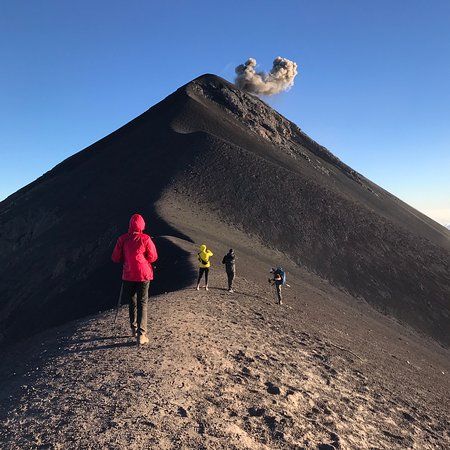 a group of people standing on top of a mountain