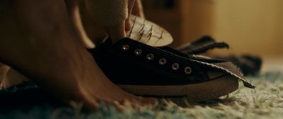 a close up of a person's shoes on a carpet