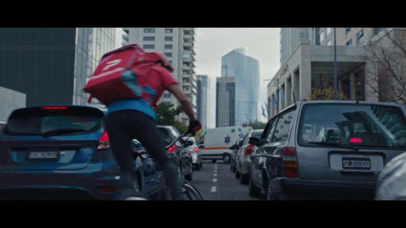 a man riding a bike down a busy street