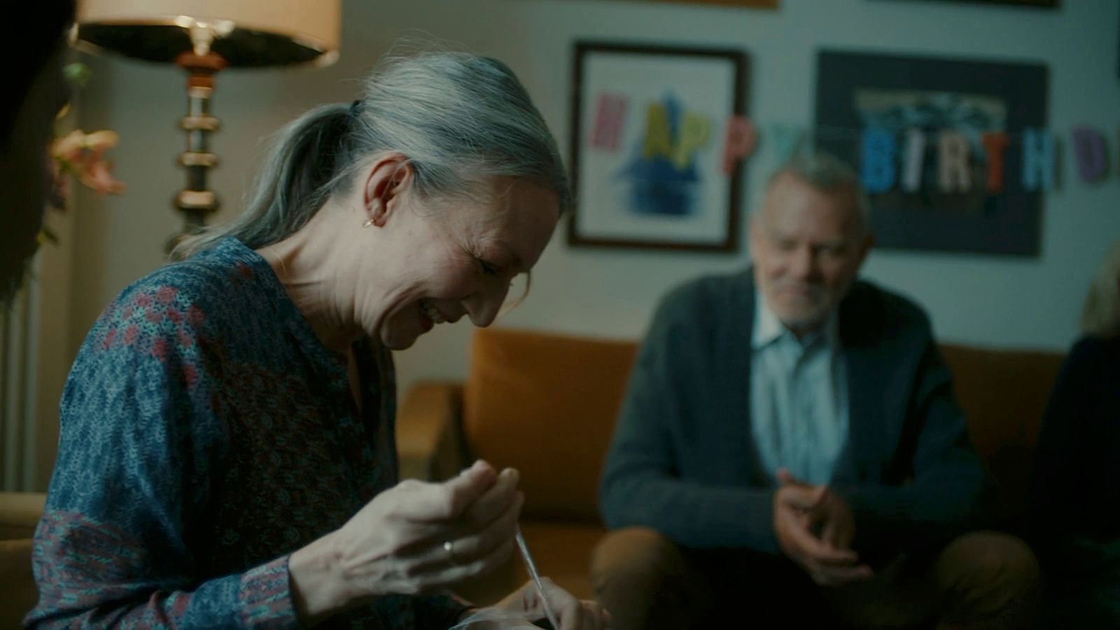 a woman sitting on top of a couch next to a man