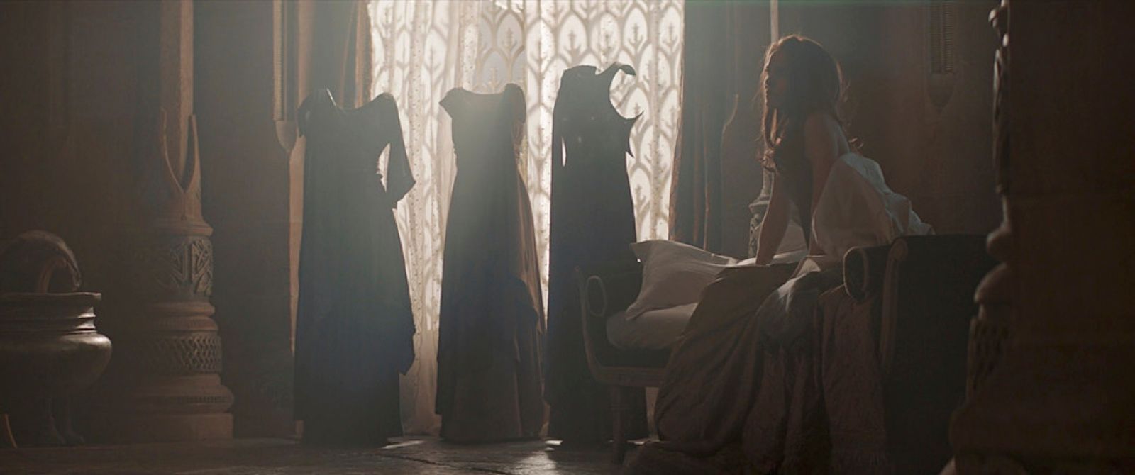 a group of women standing in a room next to a window