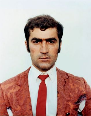 a man in a red suit and red tie