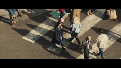 a group of people walking across a street