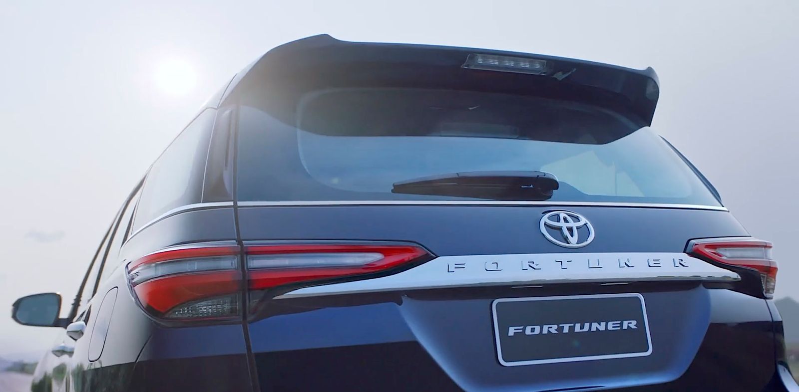 the rear end of a blue toyota fortune