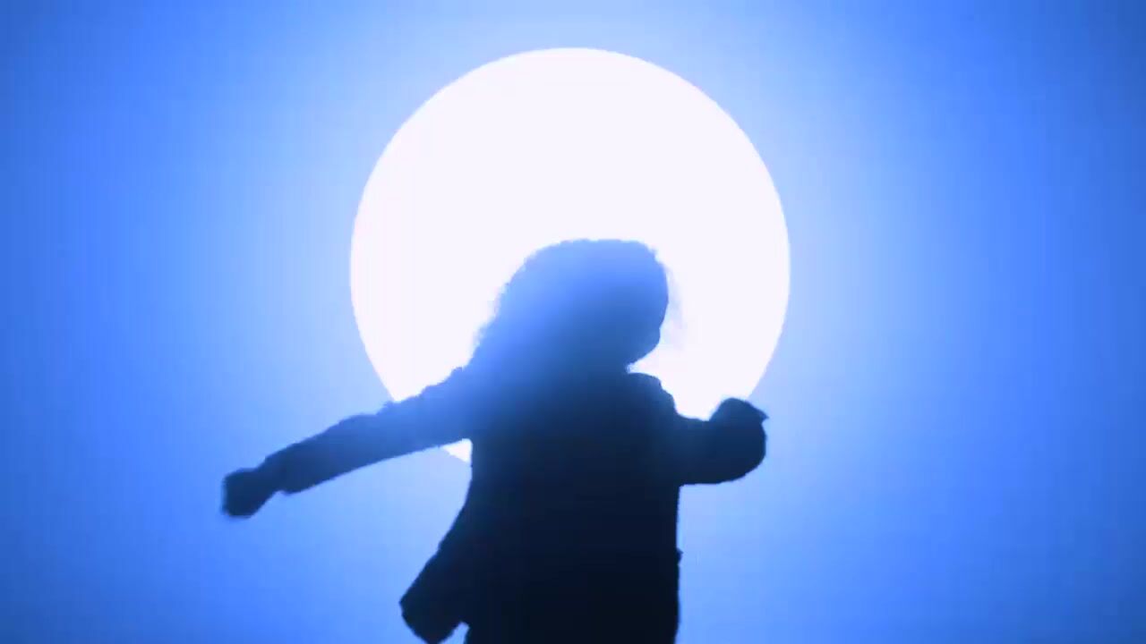 a silhouette of a person holding a bat in front of a full moon