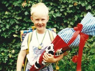 a young boy holding a red and blue toy