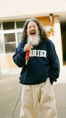 a man with a long beard and a microphone