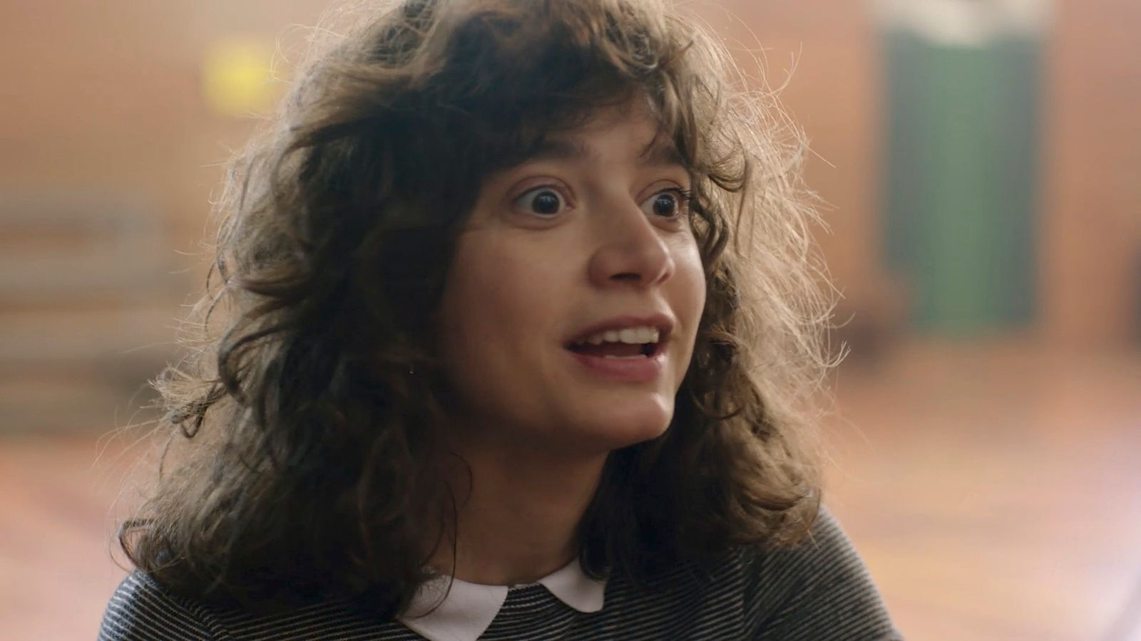 a close up of a person with curly hair