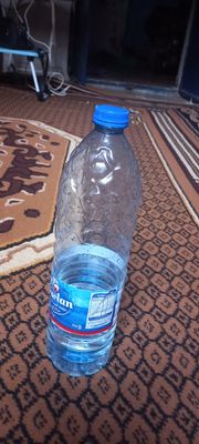 a bottle of water sitting on top of a rug