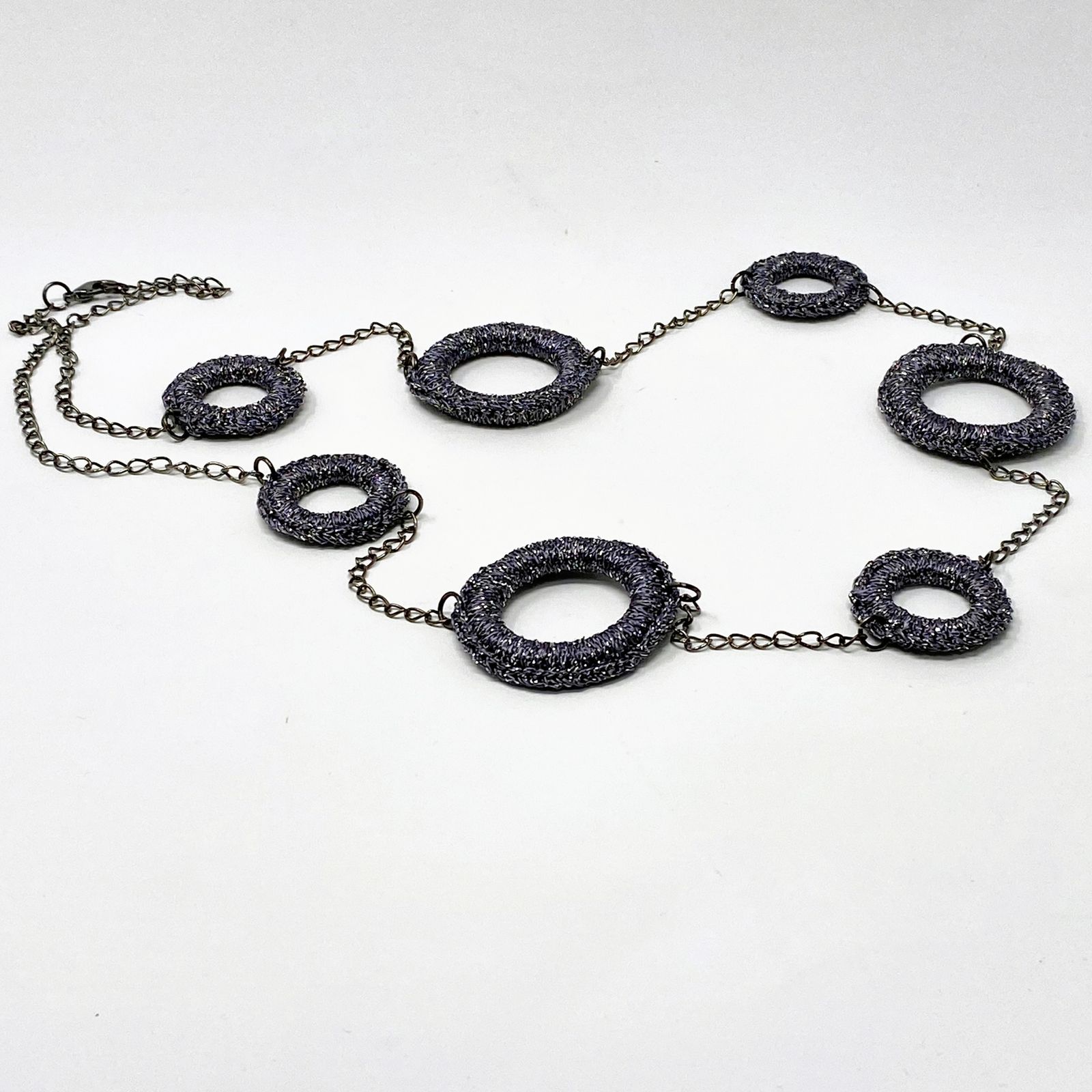 a necklace with black beads on a chain