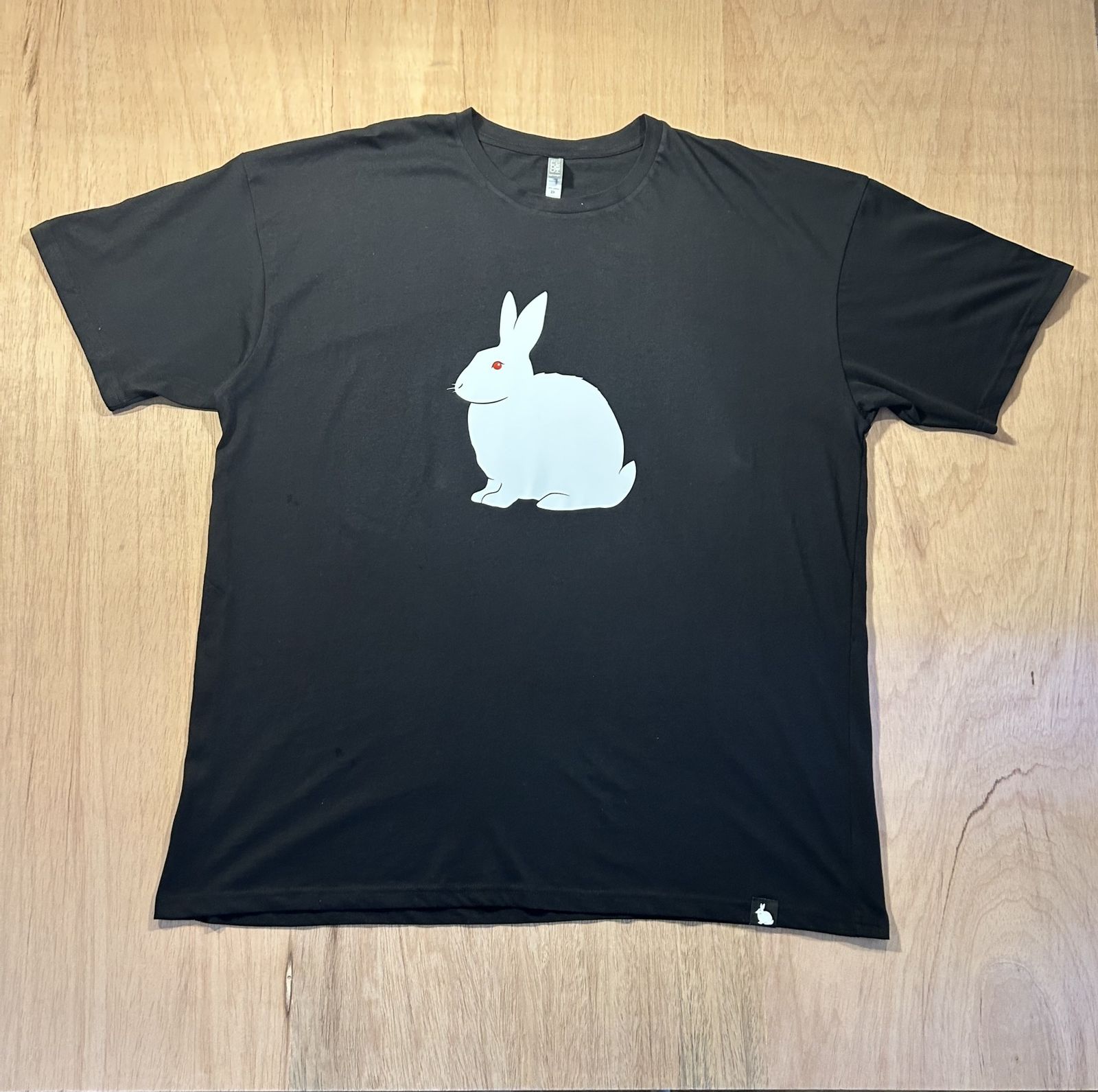 a black shirt with a white rabbit on it