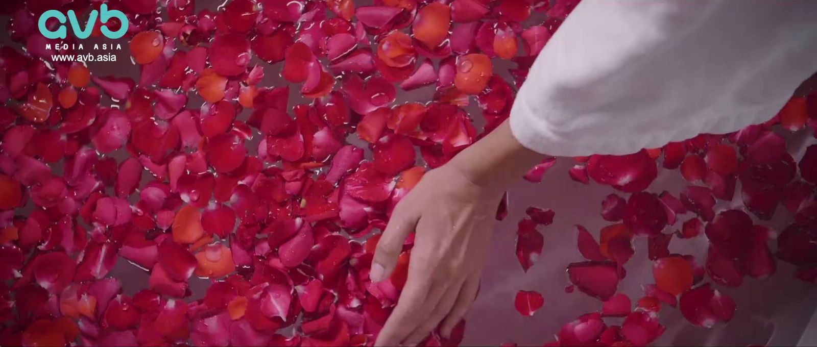 a woman standing in front of a wall covered in hearts