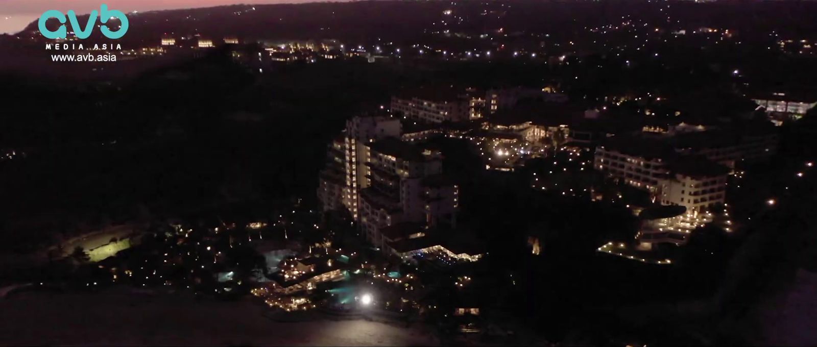 a view of a city at night from a hill