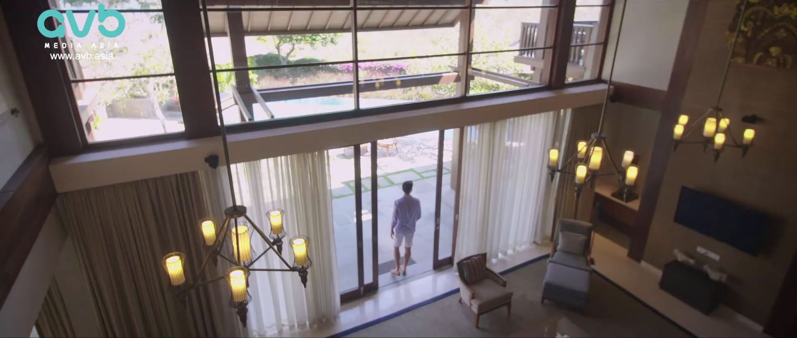 a man is standing in the doorway of a house