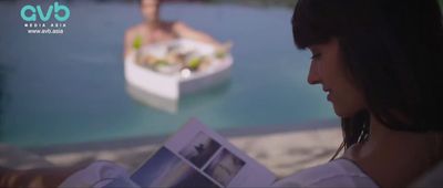 a woman reading a book in front of a boat