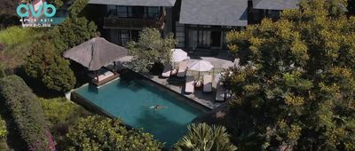 an aerial view of a house with a swimming pool