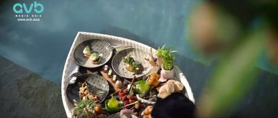 a boat filled with lots of food on top of a body of water