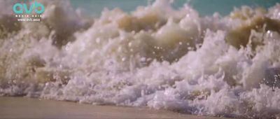 a picture of a wave crashing on the beach