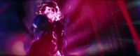 a blurry image of a woman singing into a microphone