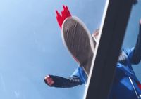 a person in a blue jacket is flying through the air