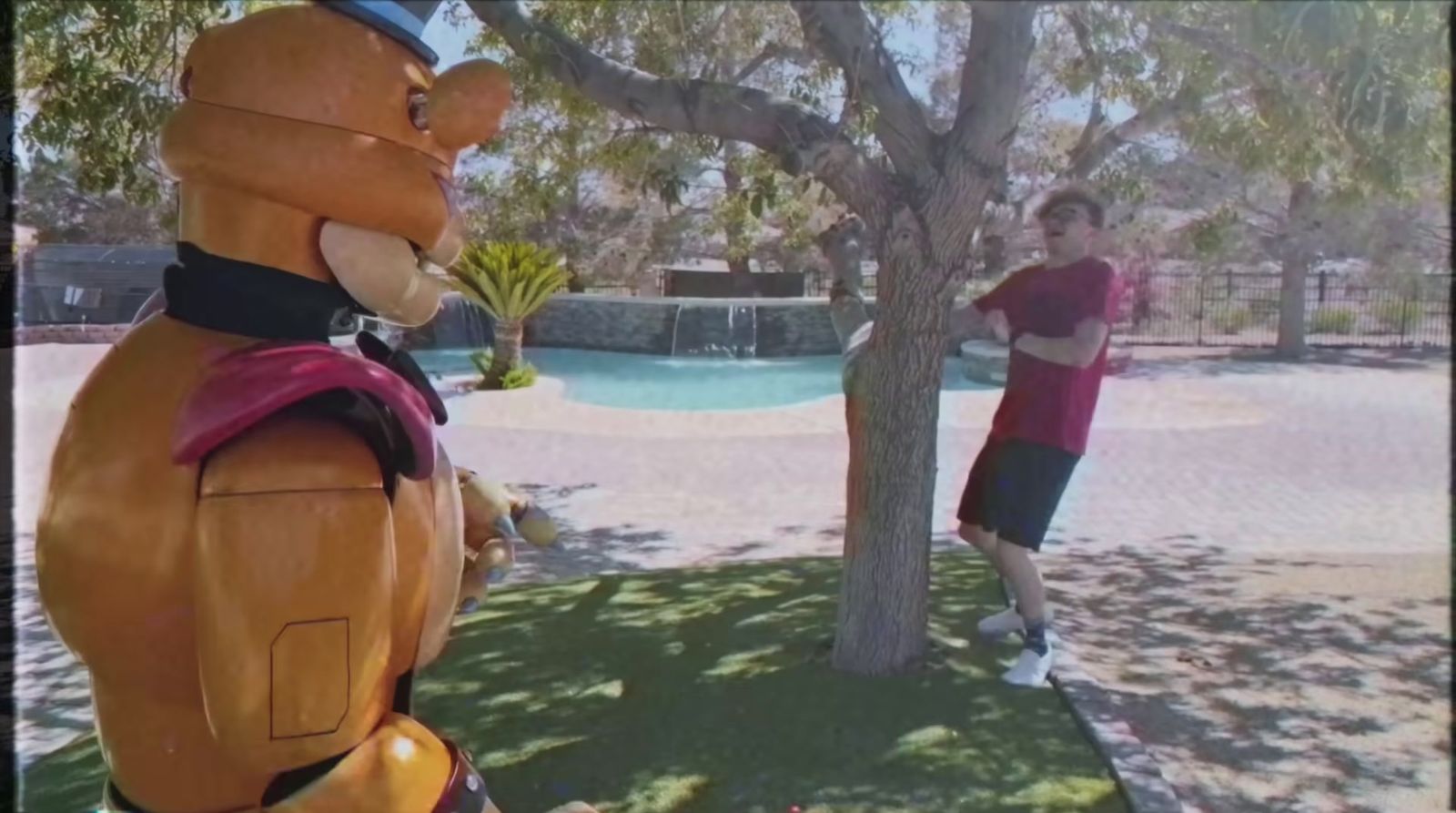 a man standing next to a giant inflatable bear