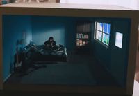 a person sitting on a bed in a room