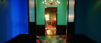 a hallway with a chandelier and green walls