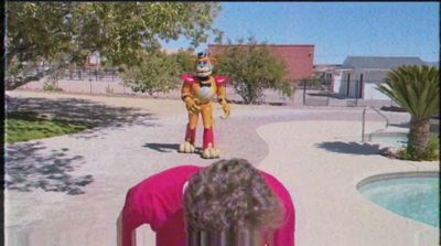 a person in a pink shirt looking at an inflatable dog