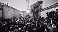 a large group of people standing in front of a building