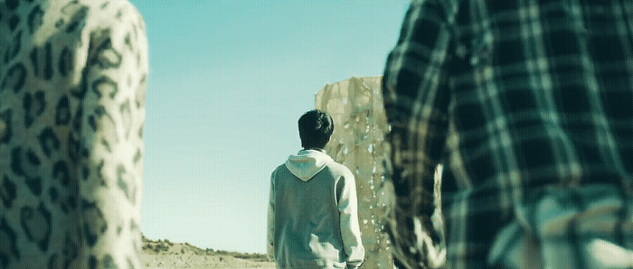 a man standing in the middle of a desert