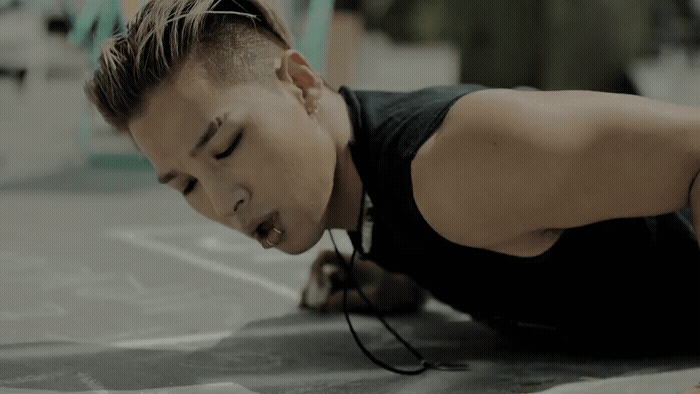 a young man is doing push ups on the ground