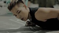 a young man is doing push ups on the ground